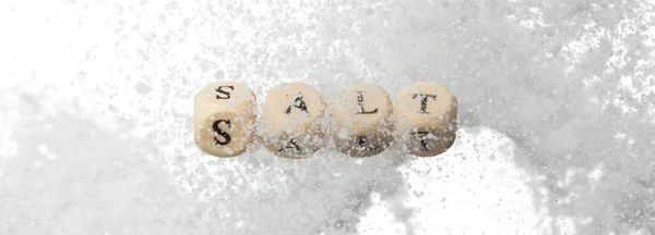 Salt alphabet letter word bead fly with crystal sodium. Less Salty concept to reduce seasoning food. Salt letter word on health care concept. White background isolated
