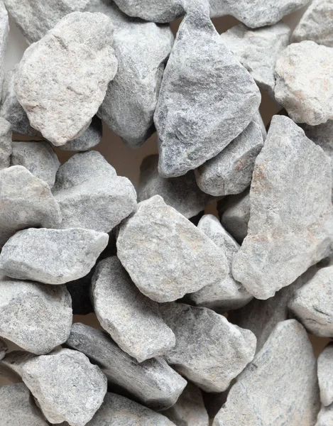 Pile of construction gravel stone lie in group, gray rock gravel show close up texture and dust, object design. White background isolated freeze shot