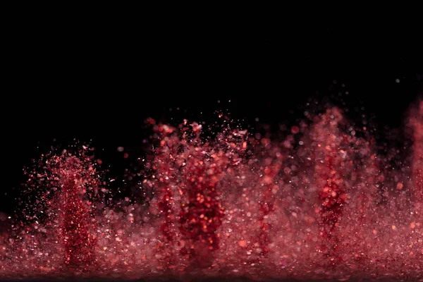爆炸金属红色闪烁着闪光 玫瑰闪粉火花闪烁庆祝 模糊的箔在空气中爆炸 飞溅出红色的闪光颗粒 黑色背景孤立 选择性焦距模糊 — 图库照片