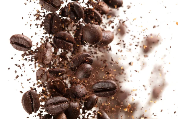 Coffee bean powder fly explosion, Coffee crushed ground float pouring, wave like smoke smell. Coffee bean powder splash throwing in mid Air. White background Isolated selective focus blur