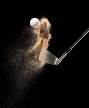 Kum sığınağından golf topu tişörtü patladı. Golfçü topa sopayla vurdu, kumdan yeşile. Golf sopası, kum deposu patlamasında topa vurdu. Siyah arkaplan izole edilmiş dondurucu hareket