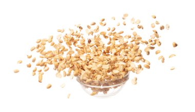 Roasted Peanut bean fall throw up in glass bowl, Roasted Peanut bean float explode, abstract cloud fly. Roasted Peanut beans splash throwing in Air. White background Isolated high speed shutter