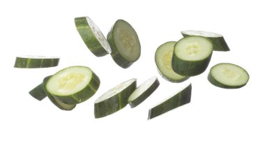 Cucumber fly fall, green fresh vegetable cucumber cut chop slice. Organic fresh vegetable with eaten leaf of long cucumber, close up texture. White background isolated freeze motion high speed shutter