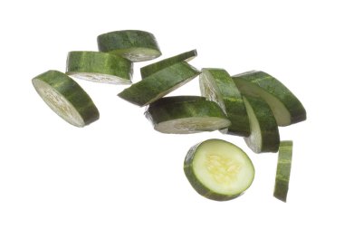 Cucumber fly fall, green fresh vegetable cucumber cut chop slice. Organic fresh vegetable with eaten leaf of long cucumber, close up texture. White background isolated freeze motion high speed shutter