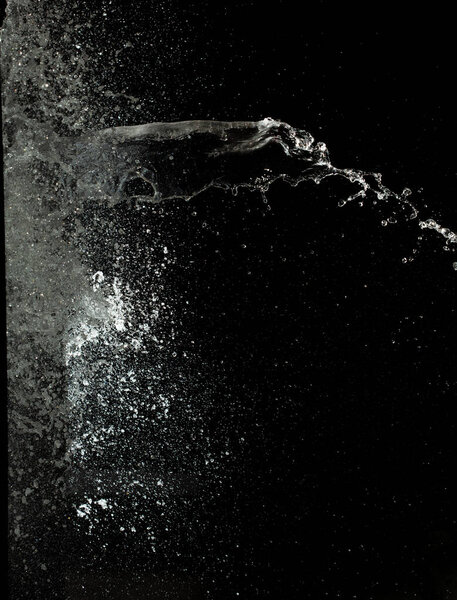 Throwing of Water splashes into drop water attack fluttering in wall floor and stop motion freeze shot. Splash Water for explosion texture graphic resource elements, black background isolated