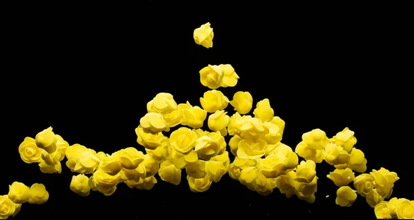 黄色的小玫瑰花爆裂了 许多花式泡沫玫瑰呈现爱情浪漫的婚礼情人 人造泡沫黄色的玫瑰在空气中飘扬 黑色背景孤立选择性焦点模糊 — 图库照片