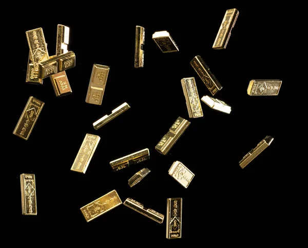 Chinese ornament gold ingot bar. Decoration element of chinese gold ingots or Yuanbao money for Festival. Other language mean rich wealthy prosperity. Black background isolated