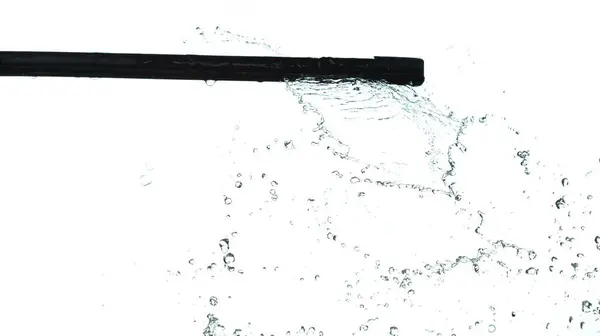 Wiper Blade Arm swipe heavy rain fall in drop wave on car vehicle. wiper blade arm work window on automobile with water rain spill droplet. White background isolated high speed shutter freeze motion