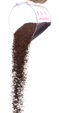 Coffee powder fall down pour in measured cup, Coffee crushed float explode, abstract cloud fly. Coffee dust powder splash throwing in Air. White background Isolated high speed shutter, freeze motion