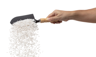 Perlite rock flying explosion, perlite white stone fall down from hand shovel garden. Perlite volcano stone splash throwing in Air. White background Isolated high speed shutter, freeze action