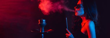 Nargile havası. Kız nargile içmekten zevk alıyor, Sheesha. Mesajın için yer aç. Yatay geniş fotoğraf altyazı