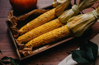 Masanın üzerinde yakın planda haşlanmış mısır.