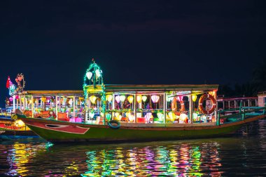 Boats decorated with burning lanterns on the river at night, Hoi An, Vietnam clipart