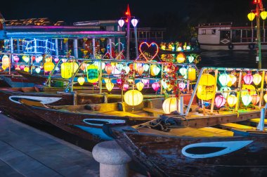 Boats decorated with burning lanterns on the river at night, Hoi An, Vietnam clipart