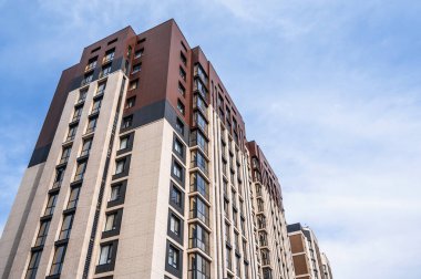 Güneşli bir günde, mavi gökyüzü olan modern bir apartman.