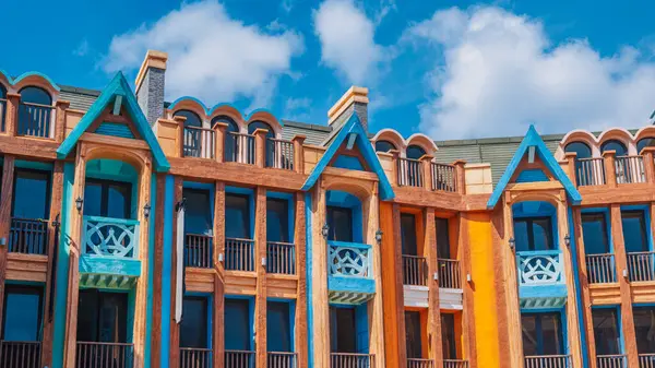 Avrupa şehrinin tarihi merkezinde, mavi gökyüzünün arka planına karşı parlak cepheli geleneksel kasaba evlerinin panoramik manzarası