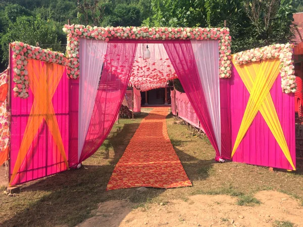 Decorative colorful entry gate for Indian marriage venue. made from cloth and wood himachal pradesh India
