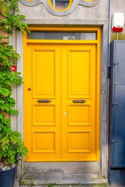 stock image Yellow wood and an old door with a gray front. Design and construction.