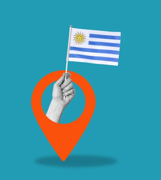 Umělecká Koláž Ruka Vlajkou Uruguaye Modrém Pozadí Navigační Značkou Koncept — Stock fotografie