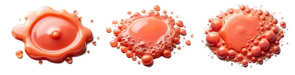 stock image Red sauce droplets form various shapes, highlighting their glossy texture on a smooth white surface.