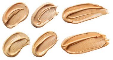 Sıvı temel seti, beyaz arka planda lekelenmiş leke. Kozmetik ve makyaj kavramı.