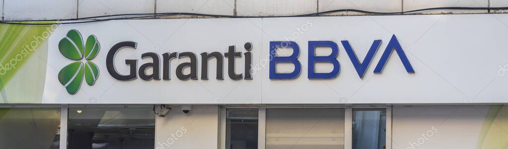 Istanbul, Turkey - June 17, 2025 Garanti BBVA logo at the entrance of the bank branch. The concept of a good and reliable bank.