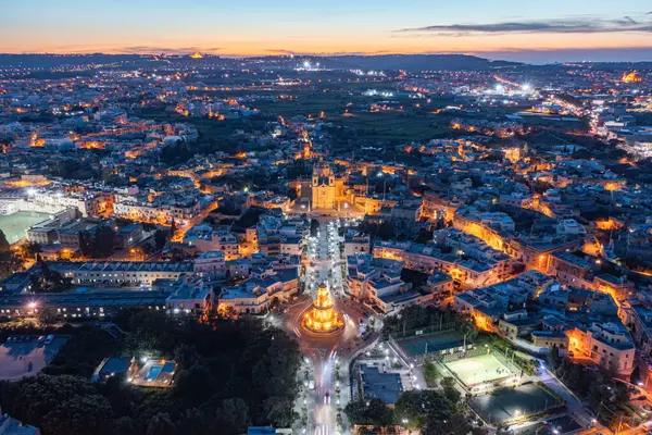 Malta 'daki Lija köyünün panoramik manzarası. Belveder Kulesi ve Kilise yanıyor. Mdina uzaktan görülebilir. Alacakaranlıkta Malta 'daki Lija köyünün hava manzarası. Belirgin aydınlatma yapıları arasında Belveder Kulesi ve Kilise yer almaktadır..