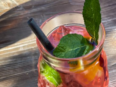 Serin, taze yaz içeceği ve yüksek açılı, ahşap masa üzerinde nane yaprağı.