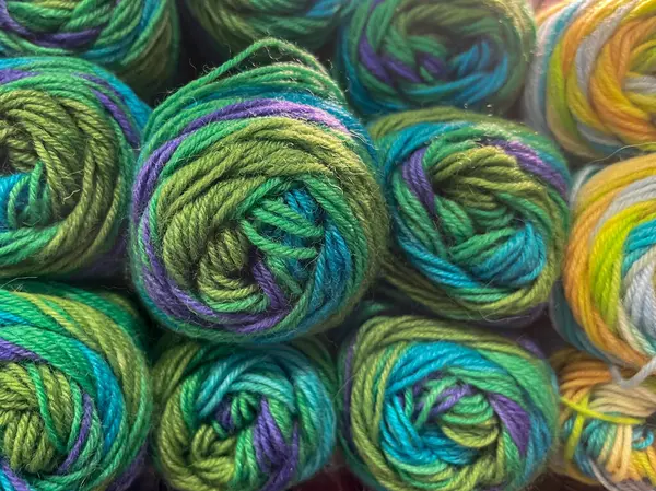 stock image multicolored knitting wool yarn thread balls with blue, green, purple, head on, close up