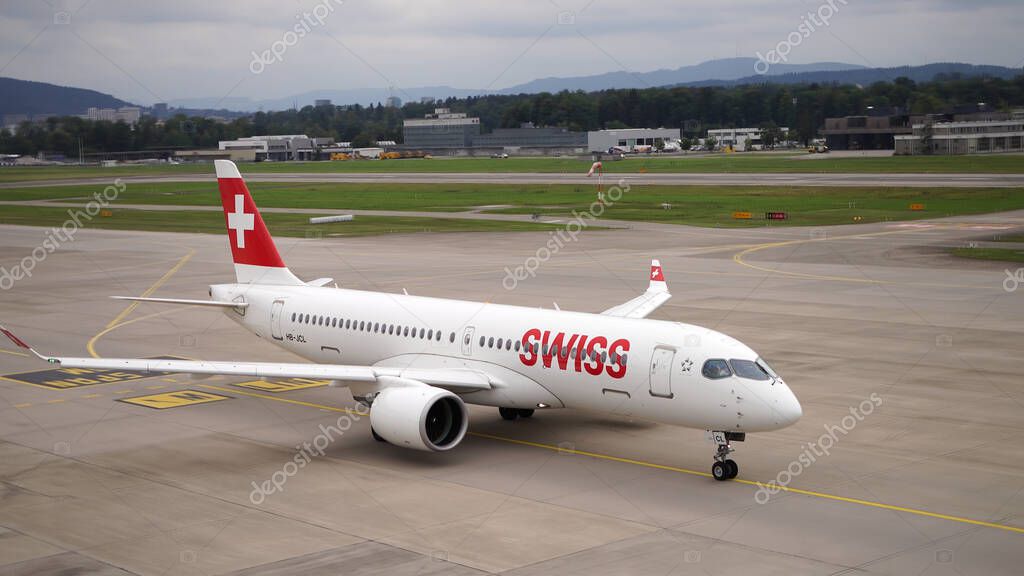 International Airport Zurich, Switzerland, Swiss Airlines Airplane registration, HB-JCL, Bombardier A220-300, taxiing on runway on a cloudy summer day, close up, high angle view front and side