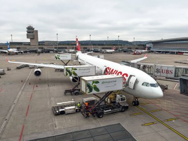 Containers of aviation Catering Gate Gourmet GmbH attached to refill Swiss Airlines airplane with meals. Zurich, International Airport, September 5, 2024 clipart