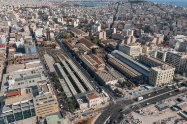 A high-angle aerial view of Piraeus Train Station and the surrounding urban infrastructure in Piraeus, Greece. This image captures the busy railway station, with its tracks extending into the city and clipart