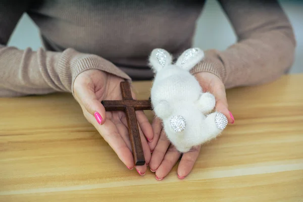 Hands holding doll with Easter concept.