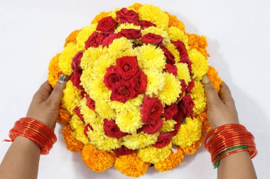 colorful flowers stacked up to create bathukamma, a specific hindu god worshiped in south india clipart