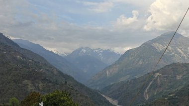 Himalaya dağları ve gökyüzünde bulutlarla dolu güzel bir manzara.