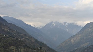 Himalaya dağları ve gökyüzünde bulutlarla dolu güzel bir manzara.