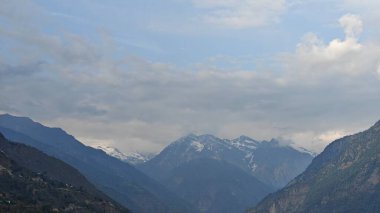 Himalaya dağları ve gökyüzünde bulutlarla dolu güzel bir manzara.