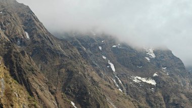 Yeşil çayırların güzel manzarası, mavi gökyüzü karlı dağlar, mağazalar, oteller ve Kedarnath Tapınağı Yolu 'na giden Shiva hayranlarından oluşan kalabalık.