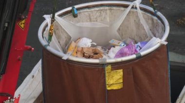 Emptying Big Garbage Container With Crane at Apartment Area. High quality 4k footage
