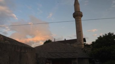 Minaret and a Small Rural Mosque at Evening, Tilt Down. High quality 4k footage