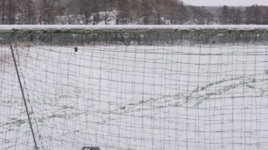 Futbol sahasında Kar İzleri Futbol Ağı 'ndan görülüyor, Pan şutu. Yüksek kalite 4k görüntü