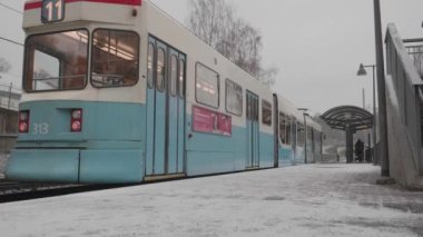 Gothenburg , Sweden Dec 14 2022: Tram departing Galileis Gata, Bergsjon at winter, Low Angle. High quality 4k footage