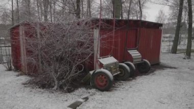 Two Wheeled Horse Carriage or Cart Parked Next to a Shed at Winter. High quality 4k footage