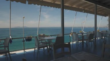 Empty Beachfront Balcony Cafe with Calm and Turquoise Mediterranean Sea. High quality 4k footage