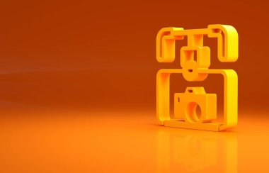 Sarı Gimbal dengeleyici ve turuncu arka planda izole edilmiş DSLR kamera simgesi. Minimalizm kavramı. 3d illüstrasyon 3B canlandırma.