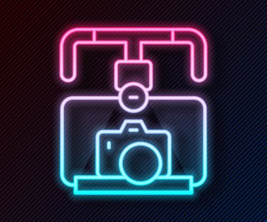 Glowing neon line Gimbal stabilizer with DSLR camera icon isolated on black background. Vector.