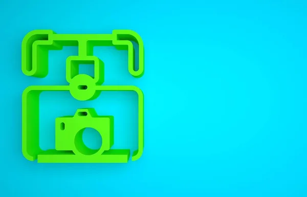 Green Gimbal stabilizer with DSLR camera icon isolated on blue background. Minimalism concept. 3D render illustration.