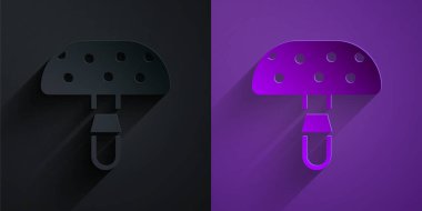 Paper cut Amanita muscaria or fly agaric hallucinogenic toadstool mushroom icon isolated on black on purple background. Spotted poisonous mushroom. Paper art style. Vector