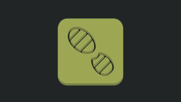 緑の人間の足跡の靴のアイコン黒の背景に隔離された 靴底だ 4Kビデオモーショングラフィックアニメーション — ストック動画