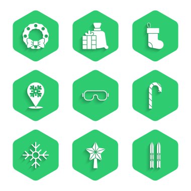 Kayak gözlükleri, Noel yıldızı ve sopalar, şeker kamışı, kar tanesi, çorap ve çelenk ikonu. Vektör